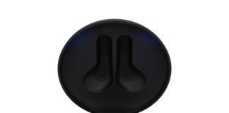 A pair of TONE Free FN7 earbuds in Stylish Black sitting inside its UVnano Charging case, which is emitting a blue light from the top of the case informing charging level and UV nano status