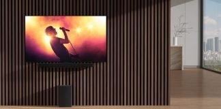 Nnew LG sSoundbar and wireless subwoofer harmonizing with an LG TV in an apartment as it displays a music concert with bright lights