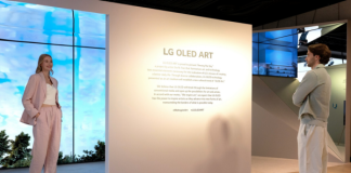 A man and a woman reading a description of the LG OLED Art exhibition on site