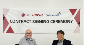 An image of Jim Gimeson (CEO of WASH) and Sam Kim (Head of the Home Appliance Division at LG Electronics USA) shaking hands at the contract signing ceremony