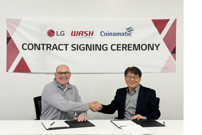 An image of Jim Gimeson (CEO of WASH) and Sam Kim (Head of the Home Appliance Division at LG Electronics USA) shaking hands at the contract signing ceremony